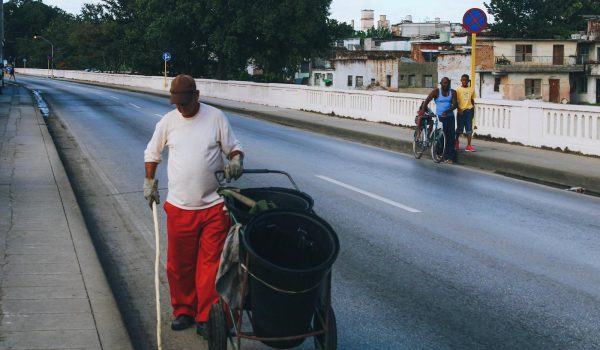 A Man Cleaning the Sidewalk